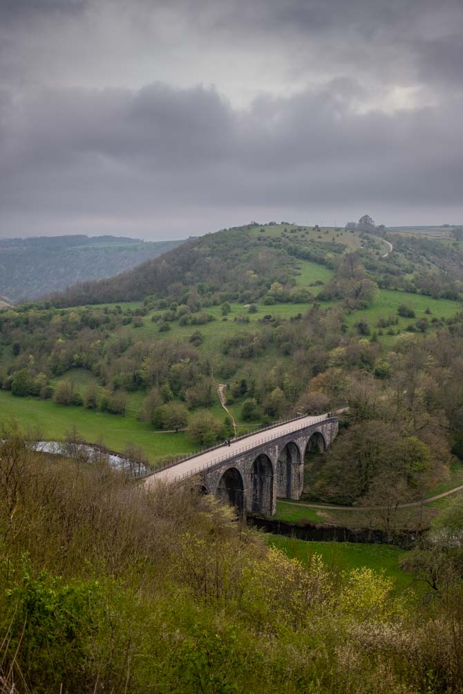 The Monsal Trail and Headstone Viaduct, viewed from Monsal Head, with a cloudy sky.