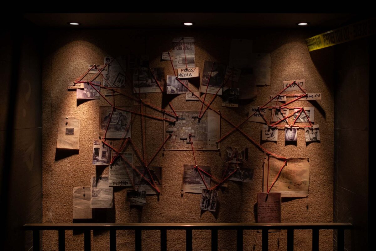 Corkboard containing imagery, newspaper clippings and strong to connect them all. 
