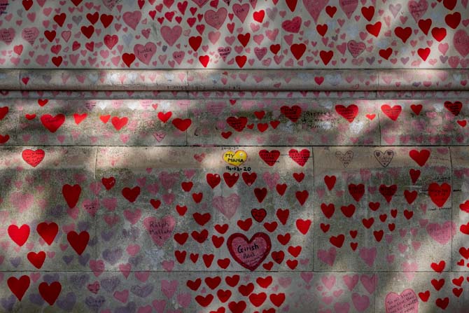 Painted hearts on a wall known as the Covid Memorial Wall.
