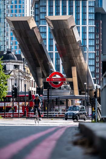 The Entrance to Vauxhall Bus Station with a cyclist and taxi in the foreground.